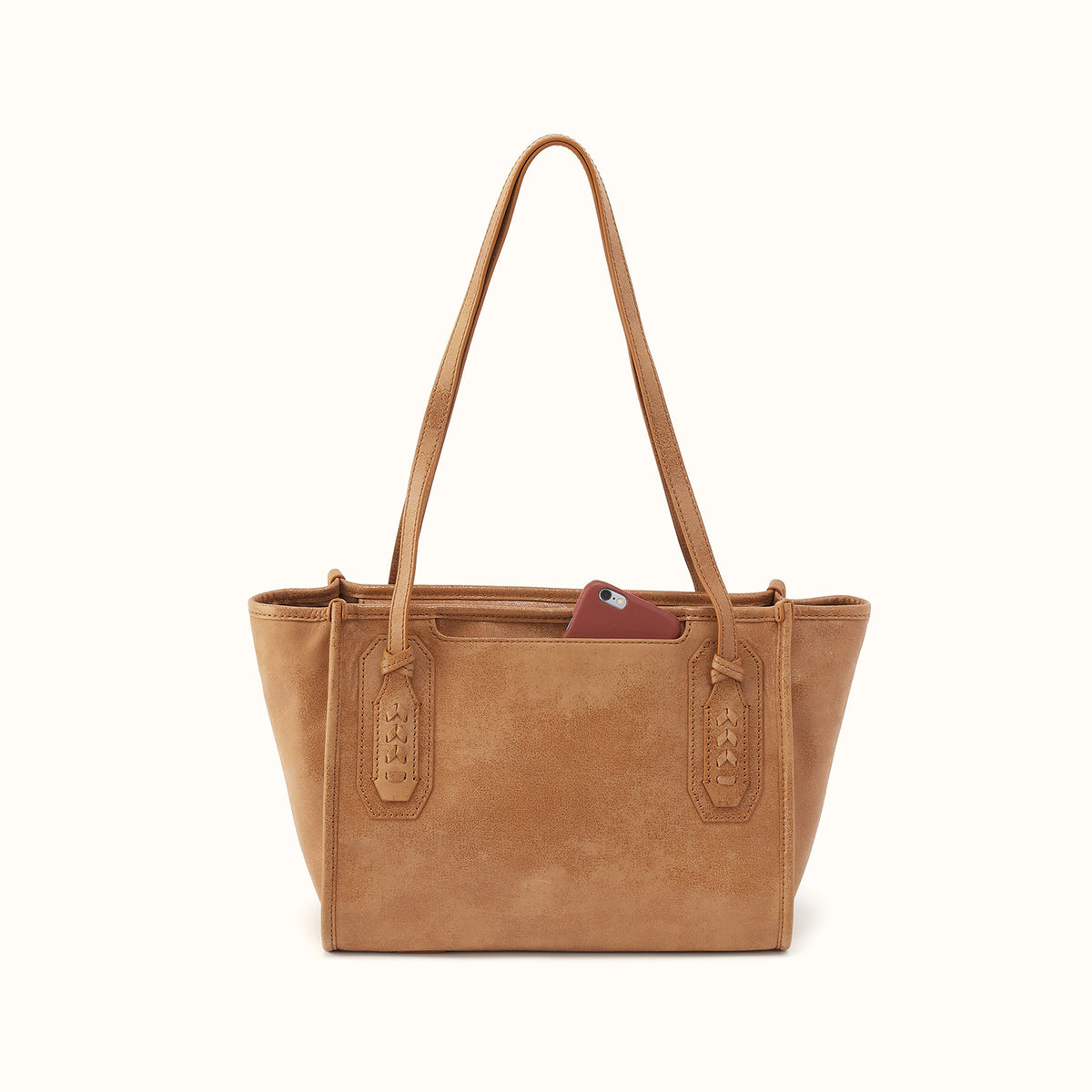 A tan leather tote bag with dual shoulder straps and a zip-around top, shown against a plain off-white background.