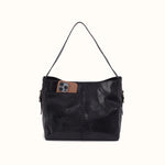 A black leather shoulder bag with a single strap, featuring a front pocket holding a brown leather phone case, set against a plain off-white background.