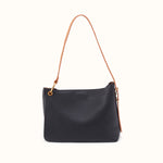 A black leather shoulder bag with a thin tan leather strap and gold-tone hardware, shown against a plain off-white background.