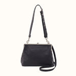 Black leather handbag with a strap on a white background