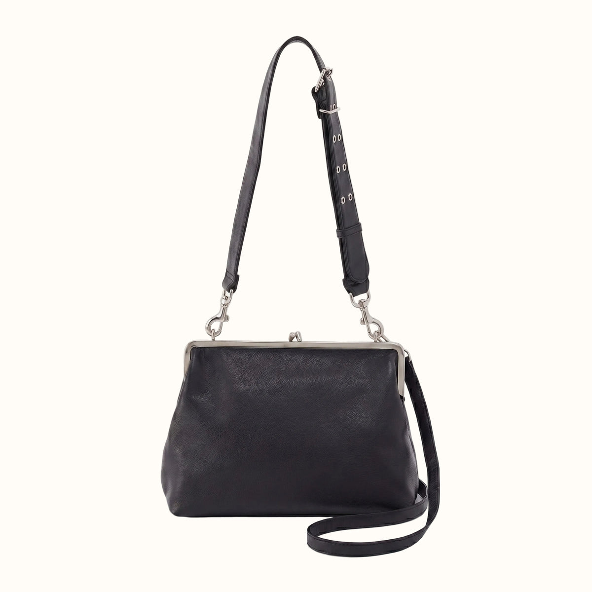 Black leather handbag with a strap on a white background