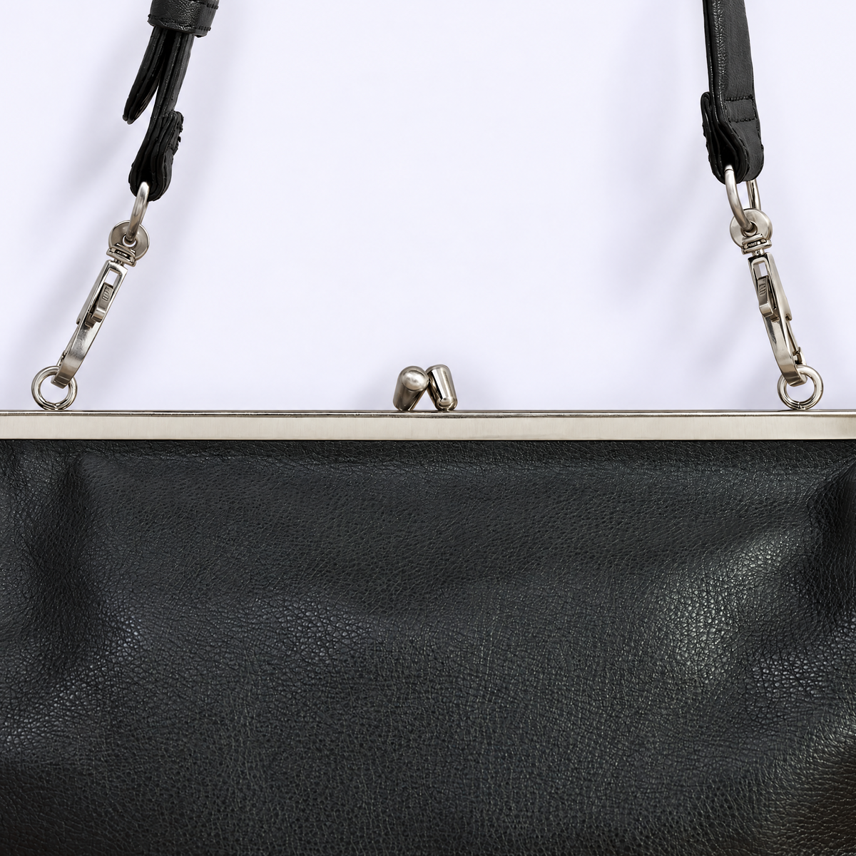 Close-up of a black pebbled leather handbag with a silver metal frame and strap clasp hardware against a plain white background.